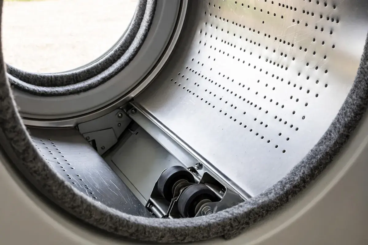 Inside of a dryer drum showing the support rollers and rear seal edge
