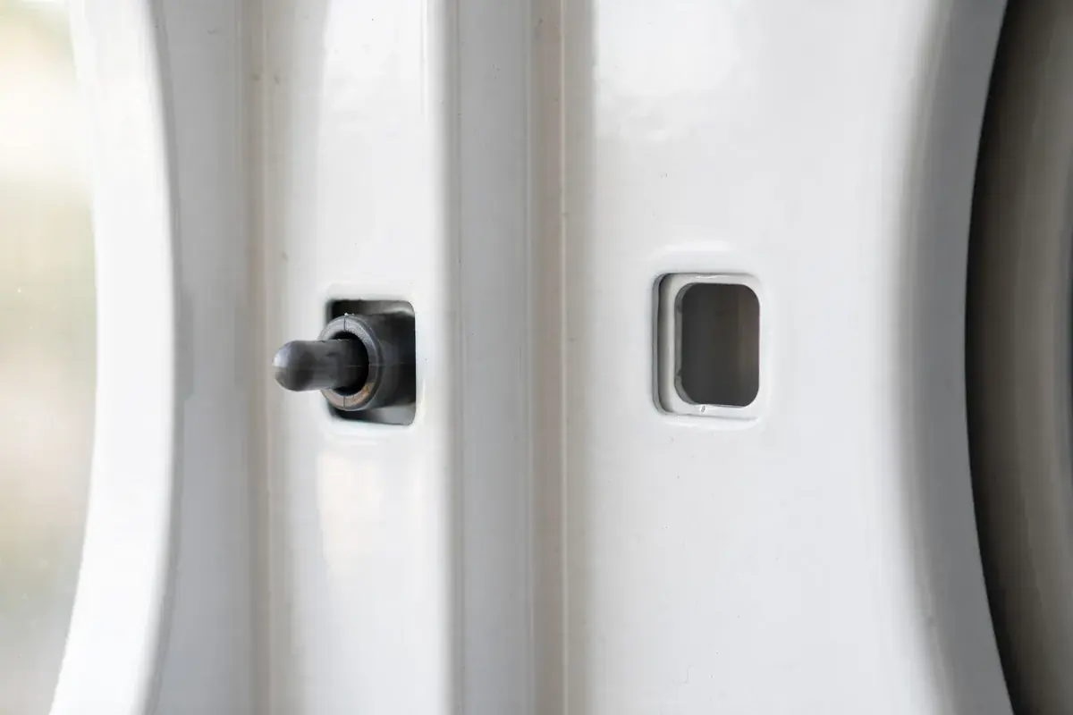 Dryer door frame with the small door switch and latch area visible